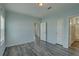 Bedroom with light blue paint, wood grain floors, lots of natural light, and a double closet at 104 1St Ave, Venice, FL 34285