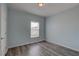 Cozy bedroom with wood-look floors and a window providing natural light at 104 1St Ave, Venice, FL 34285