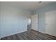 Bedroom showcases neutral walls, base moldings, and wood-look floors, with an entrance to the other room at 104 1St Ave, Venice, FL 34285