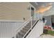 Close-up of the entrance with a stairway, railing, and the house number, 109 at 104 1St Ave, Venice, FL 34285