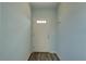 Entryway with light blue paint and wood grain floors leading to the main part of the home at 104 1St Ave, Venice, FL 34285