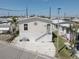 Charming single-story home featuring a light exterior, landscaped yard, and inviting entryway with white steps at 104 1St Ave, Venice, FL 34285