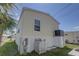 Side view of the manufactured home showcasing the white rock landscaping, a/c, and yard area at 104 1St Ave, Venice, FL 34285