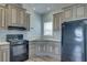 Well-lit kitchen featuring updated appliances, sleek countertops and stylish cabinetry at 104 1St Ave, Venice, FL 34285