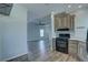 Beautiful view of the kitchen with neutral cabinets, stainless appliances, decorative backsplash, and wood grain floors at 104 1St Ave, Venice, FL 34285