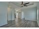 Spacious living room with recessed lighting, tray ceiling with fan, wood grain floors, and light blue paint at 104 1St Ave, Venice, FL 34285