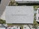 Aerial view of a well-maintained roof, showcasing modern design and durable shingles in a neutral tone at 104 1St Ave, Venice, FL 34285
