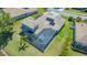 Aerial view of a home with a screened-in pool and beautiful tile roof at 1085 Mallard Marsh Dr, Osprey, FL 34229