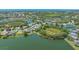 Aerial view of a lakefront property featuring a home with a screened-in patio at 1085 Mallard Marsh Dr, Osprey, FL 34229