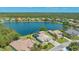 Aerial view of a home with a screened-in lanai located on a lakefront property at 1085 Mallard Marsh Dr, Osprey, FL 34229
