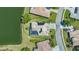Overhead shot of a single-Gathering home with solar panels, a screened-in patio, and lush backyard at 1085 Mallard Marsh Dr, Osprey, FL 34229