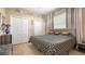 Well-lit bedroom with a large bed, double closets, neutral walls, and a light-colored floor at 1085 Mallard Marsh Dr, Osprey, FL 34229