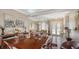 Dining room with a large wooden table, chandelier lighting, and access to the living room at 1085 Mallard Marsh Dr, Osprey, FL 34229