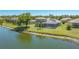 Rear exterior view of a two-story home featuring a screened-in pool and lush landscaping at 1085 Mallard Marsh Dr, Osprey, FL 34229