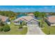 Stunning lakefront property featuring a tile roof, well-manicured lawn and three-car garage at 1085 Mallard Marsh Dr, Osprey, FL 34229