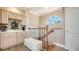 Upstairs hallway landing with railing and adjacent to custom-built bar area and storage at 1085 Mallard Marsh Dr, Osprey, FL 34229