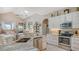 Modern kitchen with stainless steel appliances, stone countertops, and a ceiling fan at 1085 Mallard Marsh Dr, Osprey, FL 34229