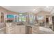 Open kitchen view highlighting marble countertops, stainless appliances, and seamless access to outdoor living at 1085 Mallard Marsh Dr, Osprey, FL 34229