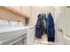 Functional laundry room equipped with a washer, dryer, storage cabinets, and hanging rack at 1085 Mallard Marsh Dr, Osprey, FL 34229