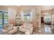 Cozy living room features neutral tones, with a comfortable white loveseat and decorative display cabinet at 1085 Mallard Marsh Dr, Osprey, FL 34229