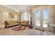 Bright living room with tile floors, modern furnishings, and views of the front yard at 1085 Mallard Marsh Dr, Osprey, FL 34229