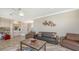 Comfortable living room with a brown sofa, natural lighting, and a view to the upstairs staircase at 1085 Mallard Marsh Dr, Osprey, FL 34229