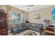Inviting living room with a large gray sectional, large windows, and decorative accents at 1085 Mallard Marsh Dr, Osprey, FL 34229