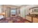 Spacious main bedroom featuring a cozy sitting area by the bay window and dresser with decorative accessories at 1085 Mallard Marsh Dr, Osprey, FL 34229