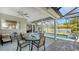 A cozy outdoor seating area with a table for dining and a view of the pool at 1085 Mallard Marsh Dr, Osprey, FL 34229