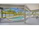 Relaxing screened-in pool and spa with a scenic backyard lake view at 1085 Mallard Marsh Dr, Osprey, FL 34229
