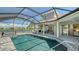 A stunning pool with a spa, screened enclosure, and beautiful lake views from the backyard at 1085 Mallard Marsh Dr, Osprey, FL 34229