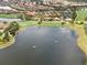 A captivating aerial view of the community and golf course, complete with a lake and manicured landscaping at 12740 Del Corso Loop, Lakewood Ranch, FL 34211