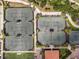 Aerial view of well-maintained tennis courts surrounded by lush landscaping at 12740 Del Corso Loop, Lakewood Ranch, FL 34211
