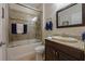 Bathroom featuring a tub/shower, granite counters, dark wood vanity, toilet and wall mounted mirror at 12740 Del Corso Loop, Lakewood Ranch, FL 34211