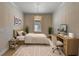 Serene bedroom featuring neutral tones, a comfortable bed, and minimalist decor at 12740 Del Corso Loop, Lakewood Ranch, FL 34211
