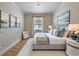 Tranquil bedroom with a plush bed, soft linens, and elegant coastal-themed artwork at 12740 Del Corso Loop, Lakewood Ranch, FL 34211