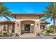 Charming clubhouse exterior featuring stone accents, arched entryway, and mature landscaping at 12740 Del Corso Loop, Lakewood Ranch, FL 34211