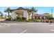 Elegant clubhouse entrance with stone accents, lush landscaping, and ample parking at 12740 Del Corso Loop, Lakewood Ranch, FL 34211
