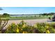 Scenic view of the golf course with water features, golf carts, and people enjoying the driving range at 12740 Del Corso Loop, Lakewood Ranch, FL 34211