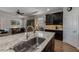 Spacious kitchen island with sink and stainless steel faucet, seamlessly connected to the living area at 12740 Del Corso Loop, Lakewood Ranch, FL 34211