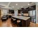 Large kitchen island with seating, granite countertops, stainless steel appliances, and custom dark wood cabinetry at 12740 Del Corso Loop, Lakewood Ranch, FL 34211