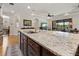 Granite kitchen island with stainless steel sink overlooking the living room at 12740 Del Corso Loop, Lakewood Ranch, FL 34211