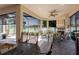 A large screened in brick paver lanai boasts a fireplace and tranquil views of the adjacent lake at 12740 Del Corso Loop, Lakewood Ranch, FL 34211