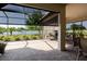 The screened lanai features brick pavers, an outdoor fireplace, and a picturesque view of the lake at 12740 Del Corso Loop, Lakewood Ranch, FL 34211