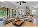 Open living room with tray ceiling, ceiling fans, and oversized sliding doors offering lots of natural light at 12740 Del Corso Loop, Lakewood Ranch, FL 34211
