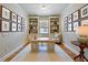 Well-lit office with built-in shelving, decorative accents, and a comfortable seating area at 12740 Del Corso Loop, Lakewood Ranch, FL 34211