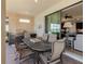 Covered outdoor dining area features a built-in grill station and a view of the home's interior at 12740 Del Corso Loop, Lakewood Ranch, FL 34211