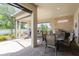 Beautiful covered outdoor living space with brick wall, outdoor kitchen and view of lake at 12740 Del Corso Loop, Lakewood Ranch, FL 34211