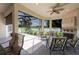 Covered patio seating overlooks a serene lake view, perfect for relaxation and entertaining at 12740 Del Corso Loop, Lakewood Ranch, FL 34211
