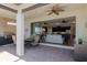 Inviting covered patio with brick flooring, ceiling fan, and an outdoor kitchen and access to the living room at 12740 Del Corso Loop, Lakewood Ranch, FL 34211